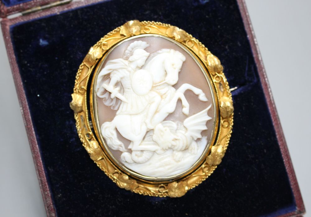 A Victorian yellow metal (tests as 15ct) mounted swivelling oval cameo brooch, carved with St George & the Dragon,